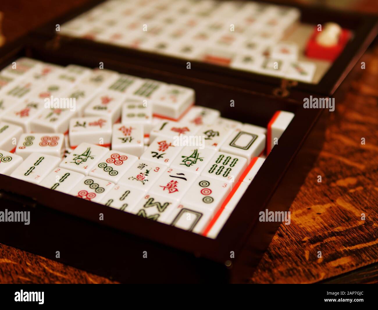 A set of Mahjong tiles in a black wooden box. Mahjong is a tile-based game  that was developed in China during the Qing dynasty Stock Photo - Alamy