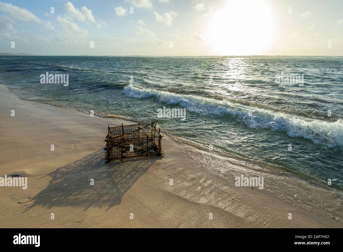 Lobster trap washed ashore Stock Photo