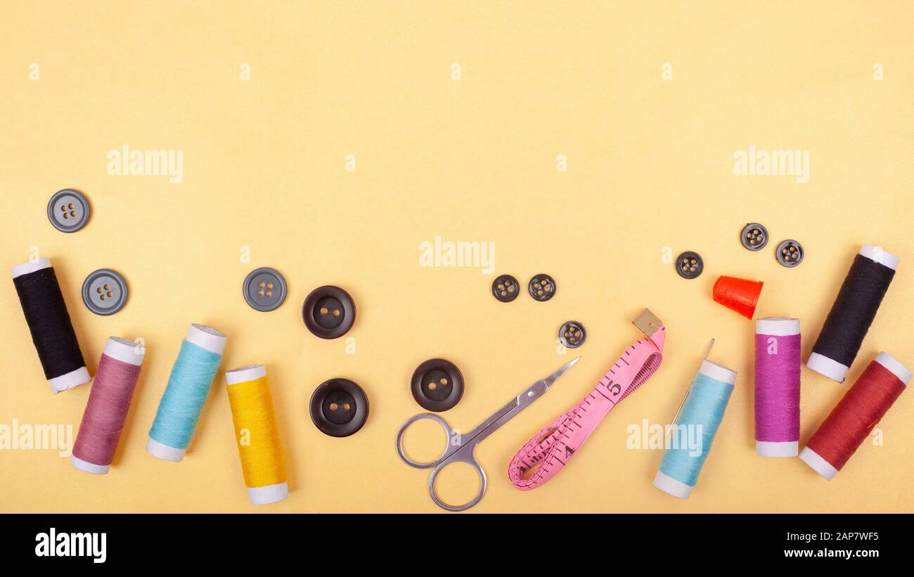 flat lay Sewing kit accessory or tailor tool workshop .Space for creative design mock up frame. threads, pins, scissors, buttons. Stock Photo
