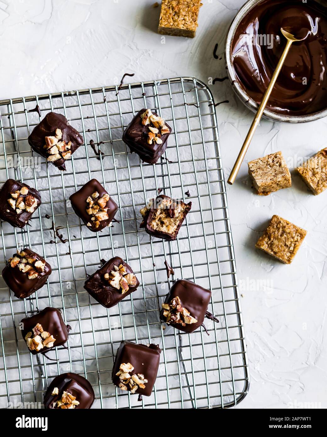 Maple pecan oat bars, dipped in dark chocolate, and sprinkled with toasted pecans on top. Stock Photo