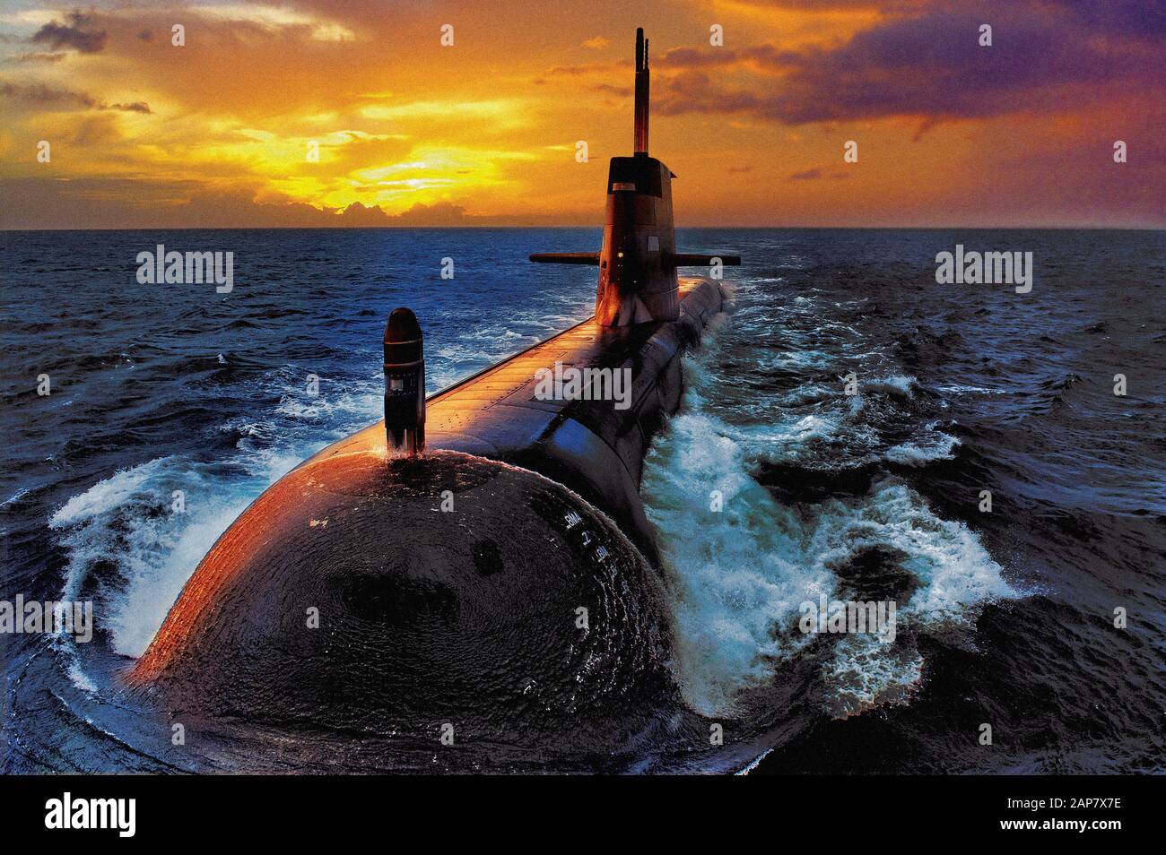 A close up view of a dramatic sunset illuminating an Australian Navy Collins Class diesel electric submarine at sea. Stock Photo