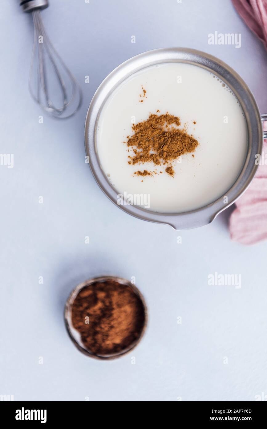 Almond milk, cinnamon and cocoa powder photographed from top view Stock