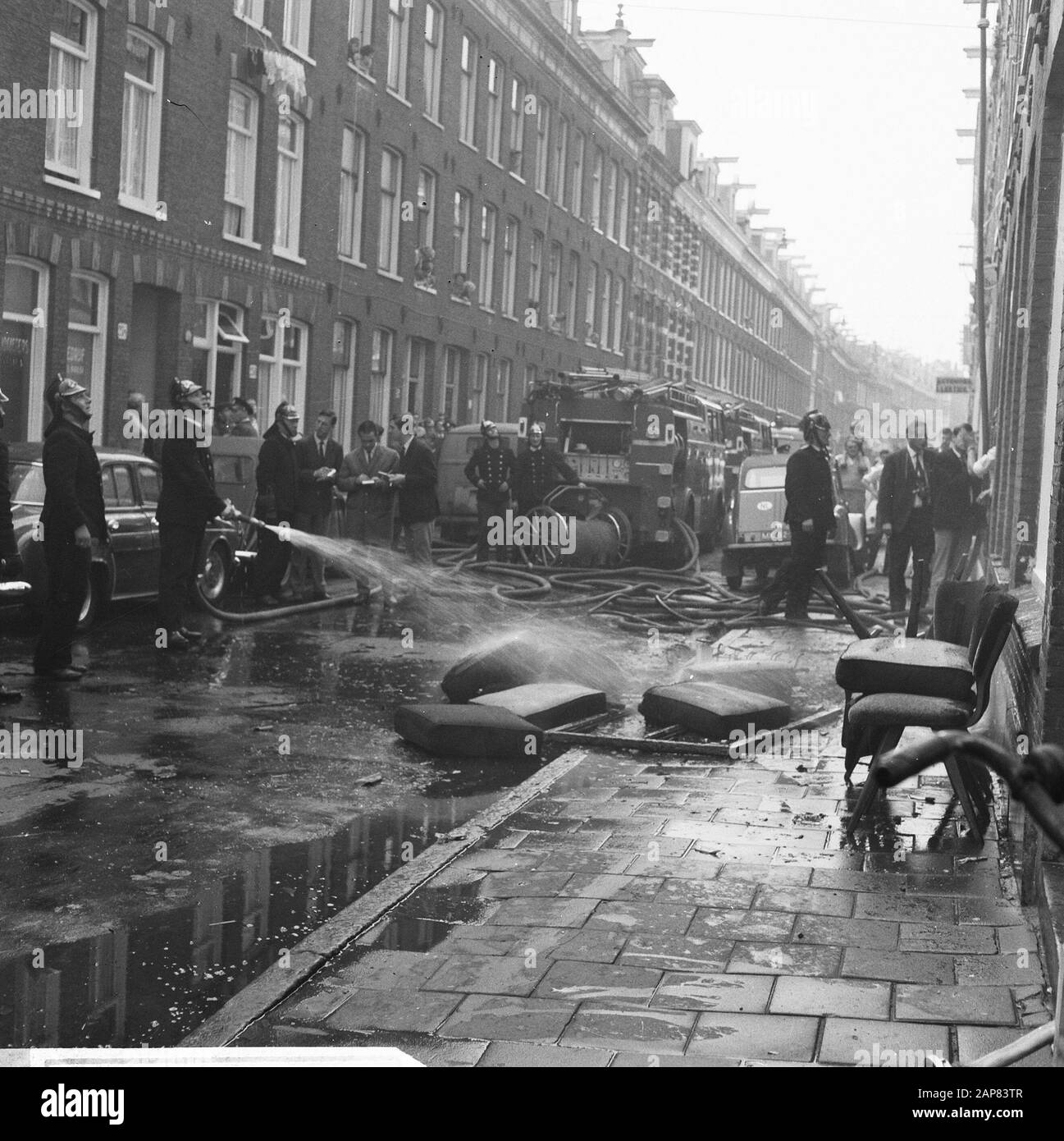 Fire in Govert Flinckstraat, fire department at the after-loop Date: 23 September 1965 Location: Amsterdam, Noord-Holland Keywords: extinguishing, fires, fire brigade Stock Photo