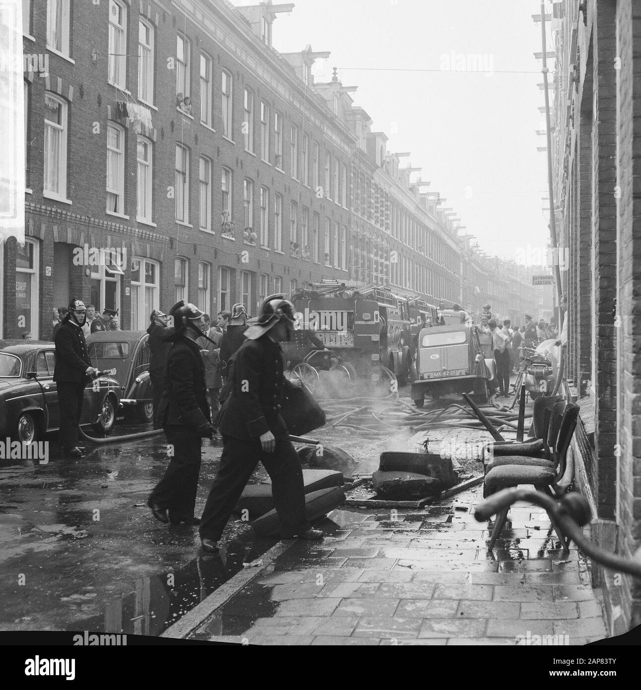 Fire in Govert Flinckstraat, fire department at the after-loop Date: 23 September 1965 Location: Amsterdam, Noord-Holland Keywords: extinguishing, fires, fire brigade Stock Photo