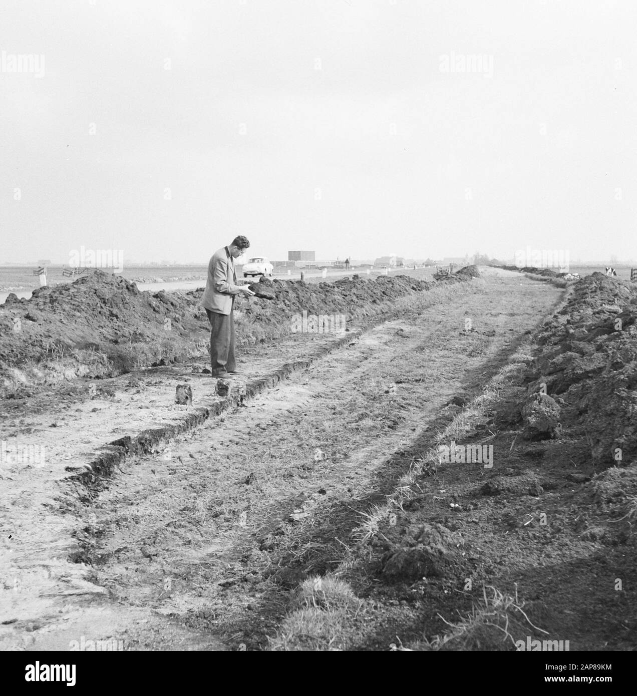 construction and improvement of roads, dikes and savings basins, cunets, stacked sods, peat, men Date: May 1962 Location: Broek in Waterland Keywords: construction and improvement of roads, cunets, dikes and savings basins, men, stacked sods, peat Stock Photo