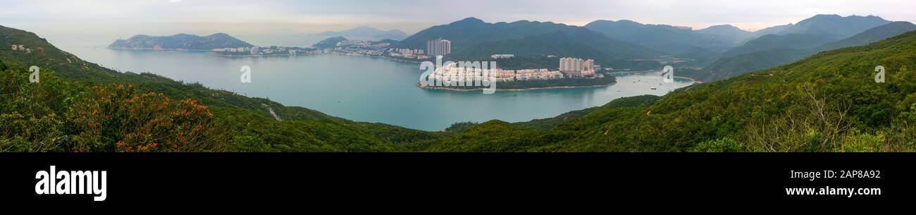 Super wide panorama of Tai Tam Bay and Red Hill in Hong Kong, as seen from Dragon's Back hiking trail Stock Photo