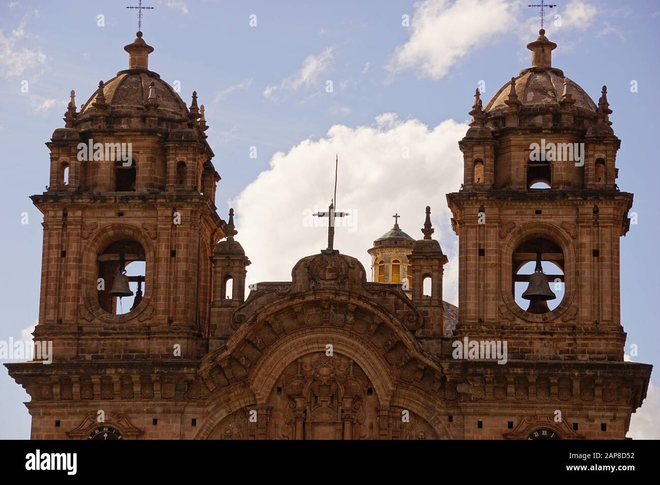 Church of the Order of Compañía de Jesús and its bell towers seen from Main Square of Cusco Peru Stock Photo