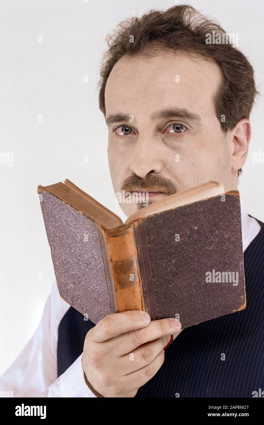Man with shirt, vest and tie holding an old book Stock Photo Alamy