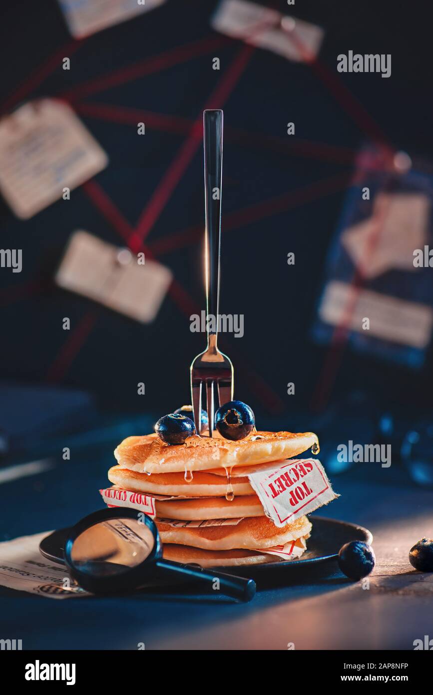 Creative food photography, a stack of pancakes with top-secret documents, spy concept Stock Photo