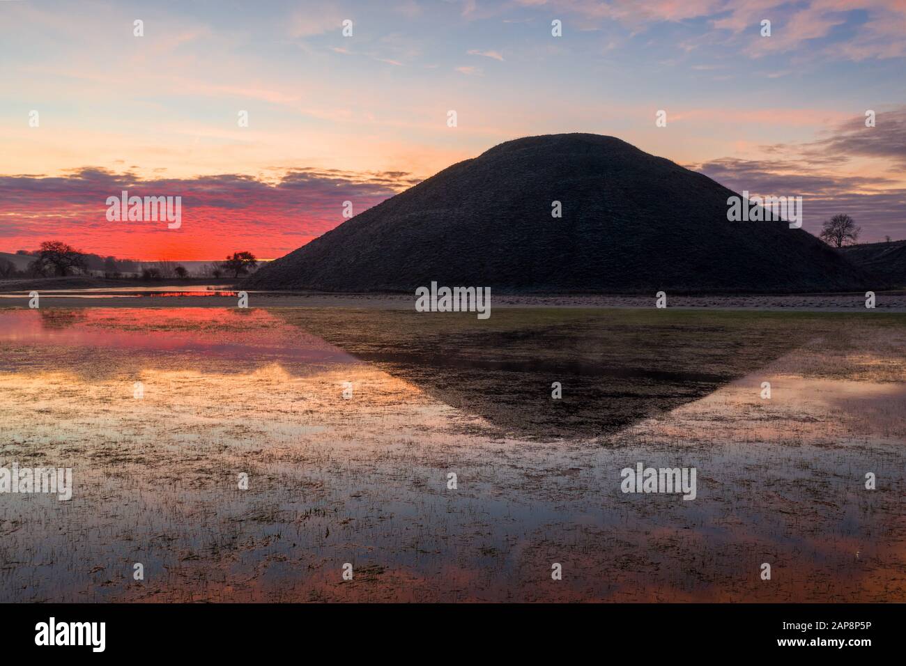 Silbury Hill, Nr Avebury, Wiltshire, UK. 20th January 2020. Drone images of a spectacular red frosty sunrise and the ancient man-made mound of Silbury Stock Photo