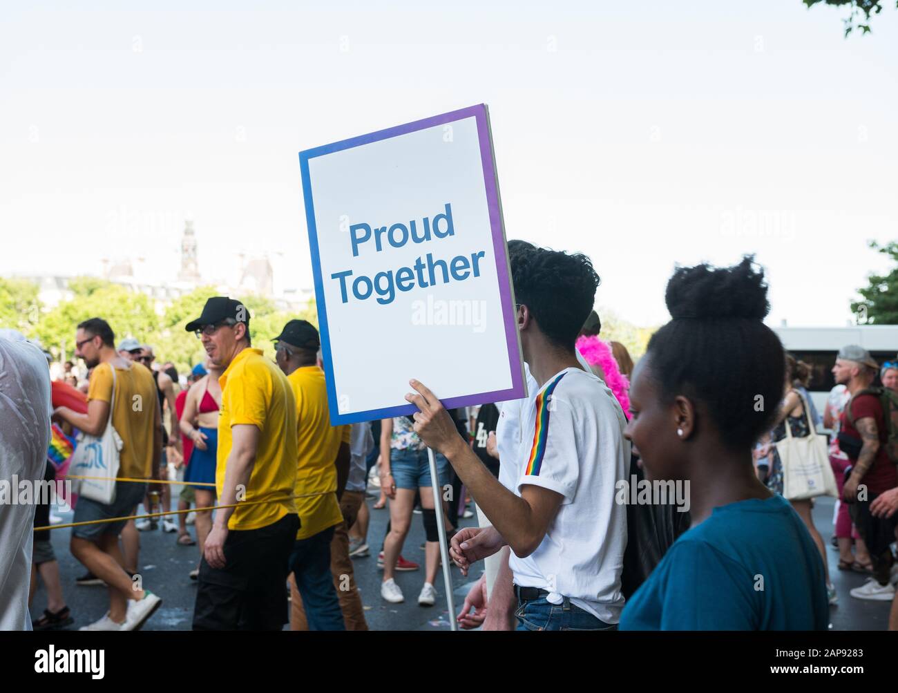 June 29 2019, Paris, France. Beautiful shot on Gay Pride Parade Day. 'Pride together'says the sign that a boy is holding in his hands through the crow Stock Photo