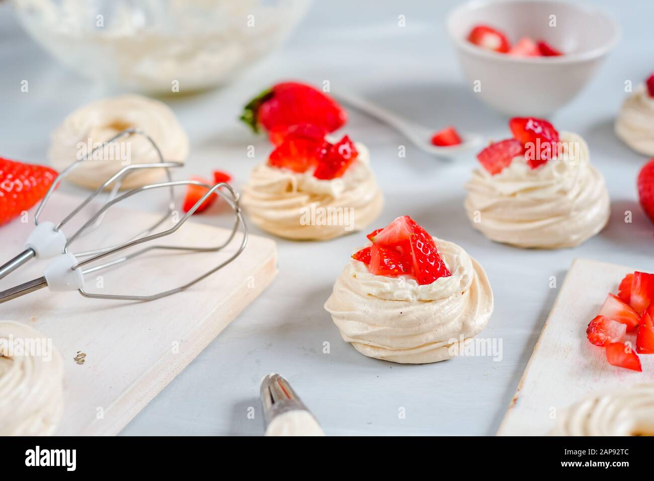 Homemade small strawberry pavlova meringue cakes pattern with cream top