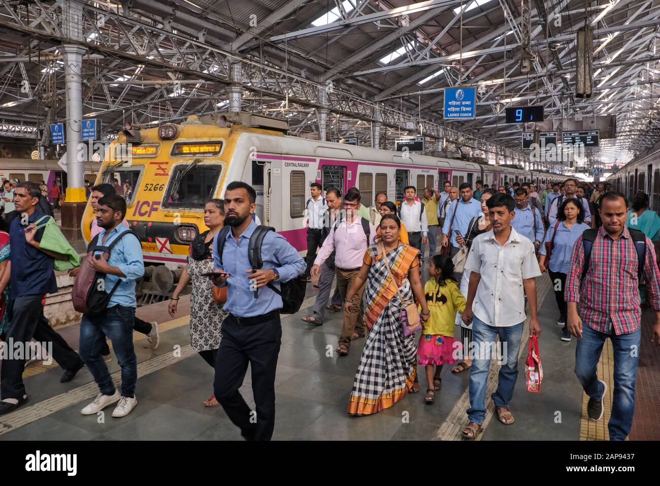 Commuters at Chhatrapati Shivaji Maharaj Terminus in Mumbai, India, disembarking from a suburban train Stock Photo