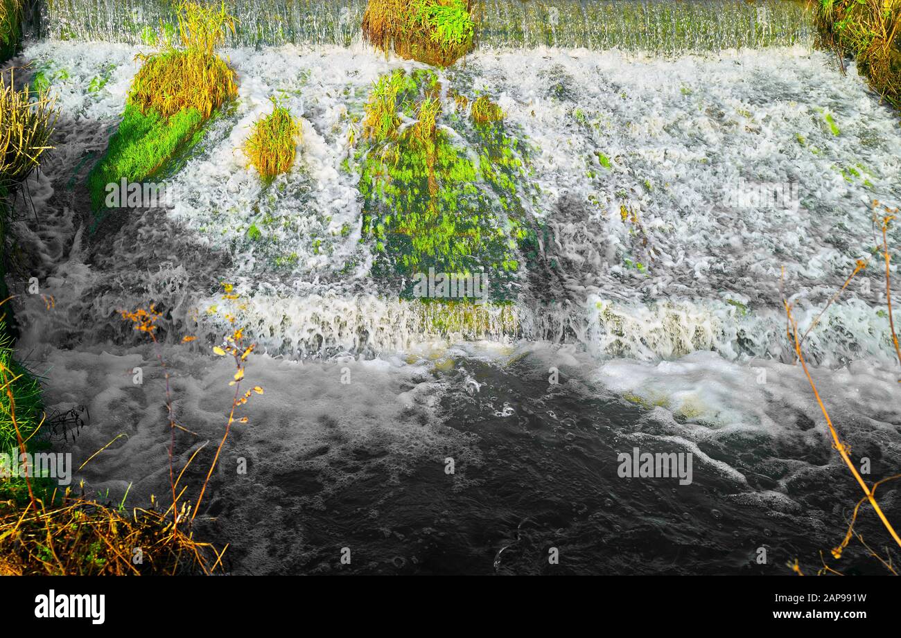 Sunlit weir on the river Wye next to Cauldwell's mill in the village of ...