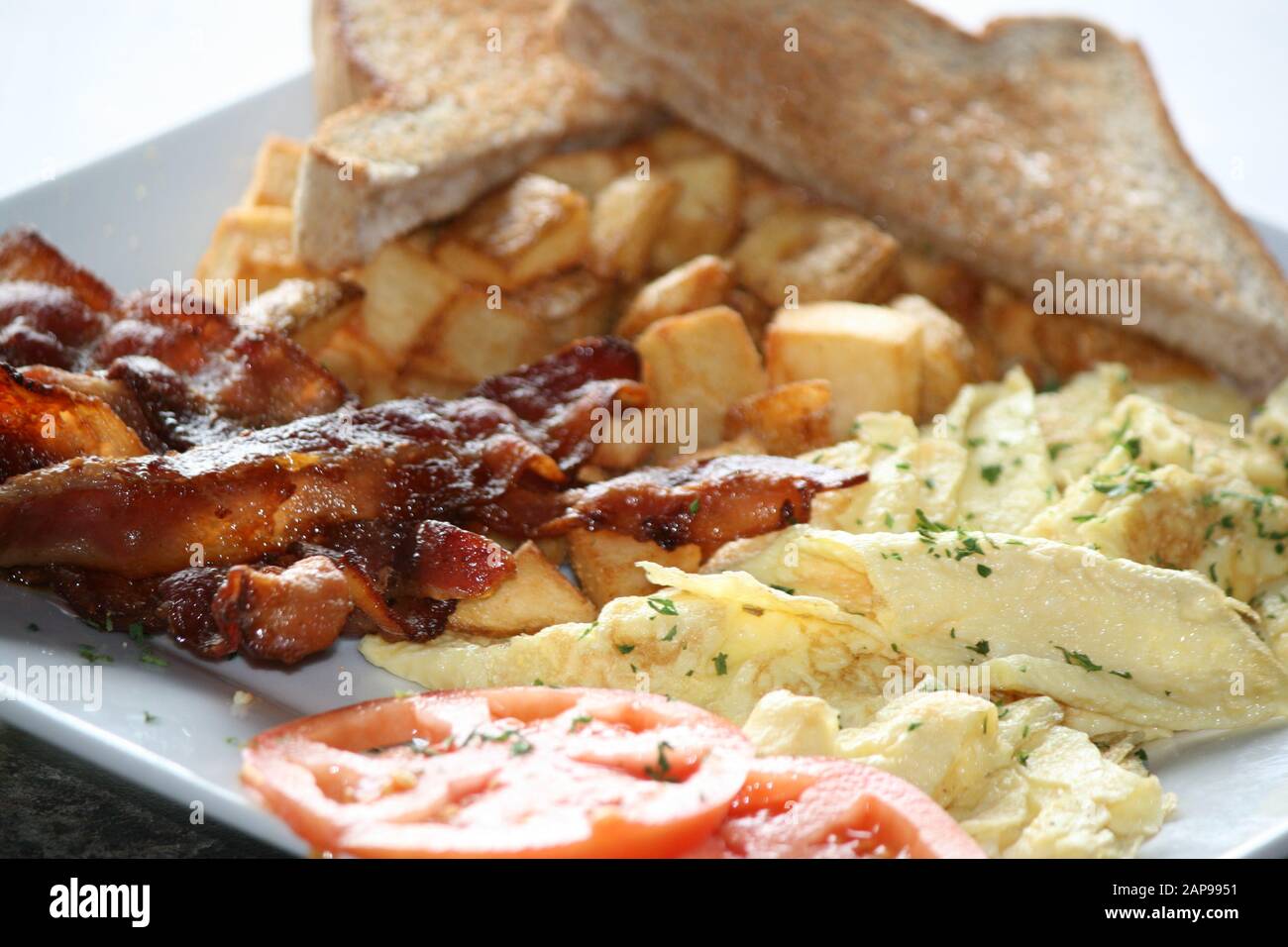 crispy well cooked pork bacon strips fried or grilled with hash browns