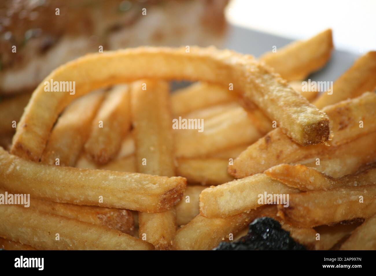 fresh potato string or straight cut french fries oven baked or deep fried as the perfect side dish at any restaurant for dine in or take out orders Stock Photo