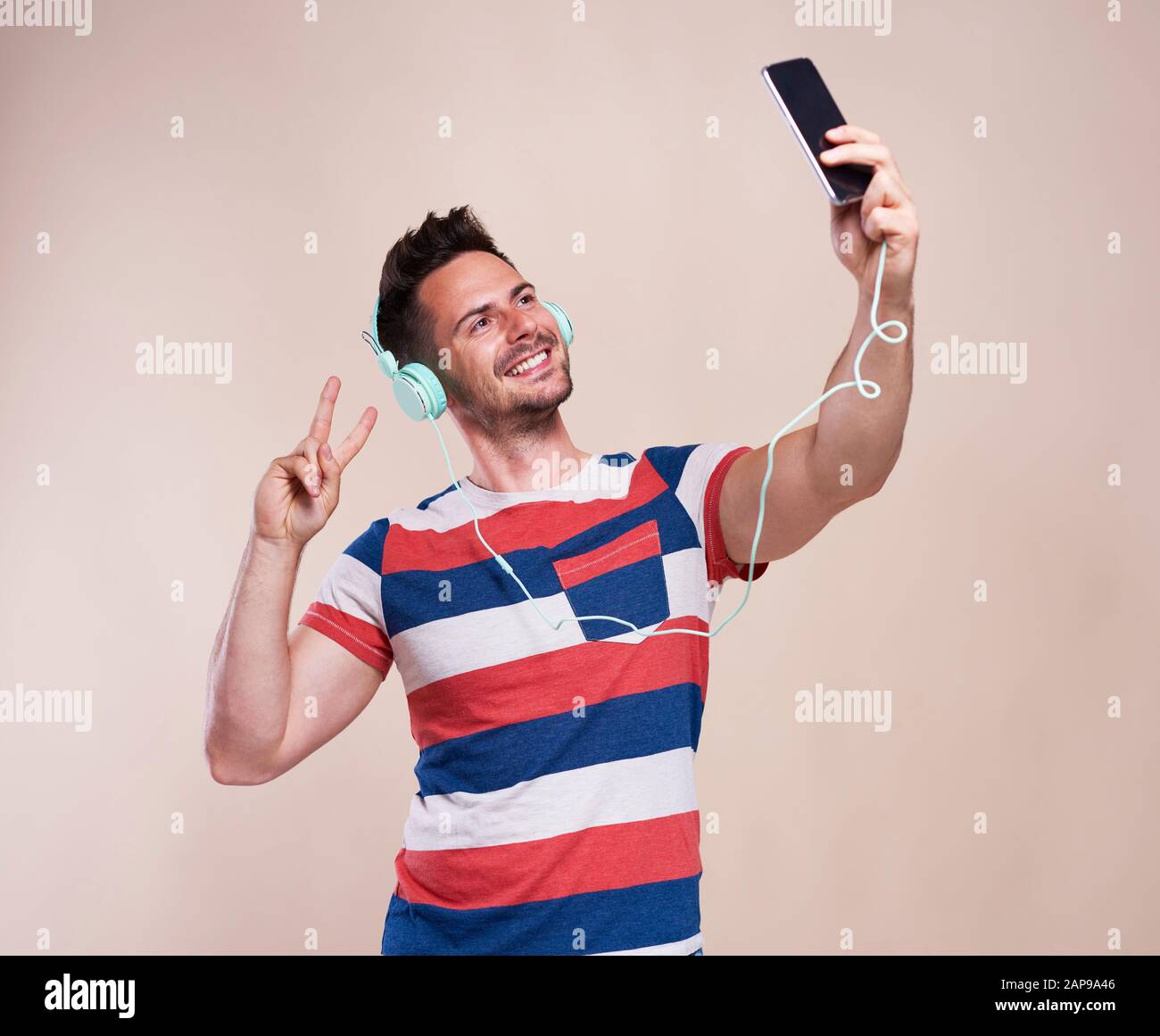 Young man making selfie in studio shot Stock Photo