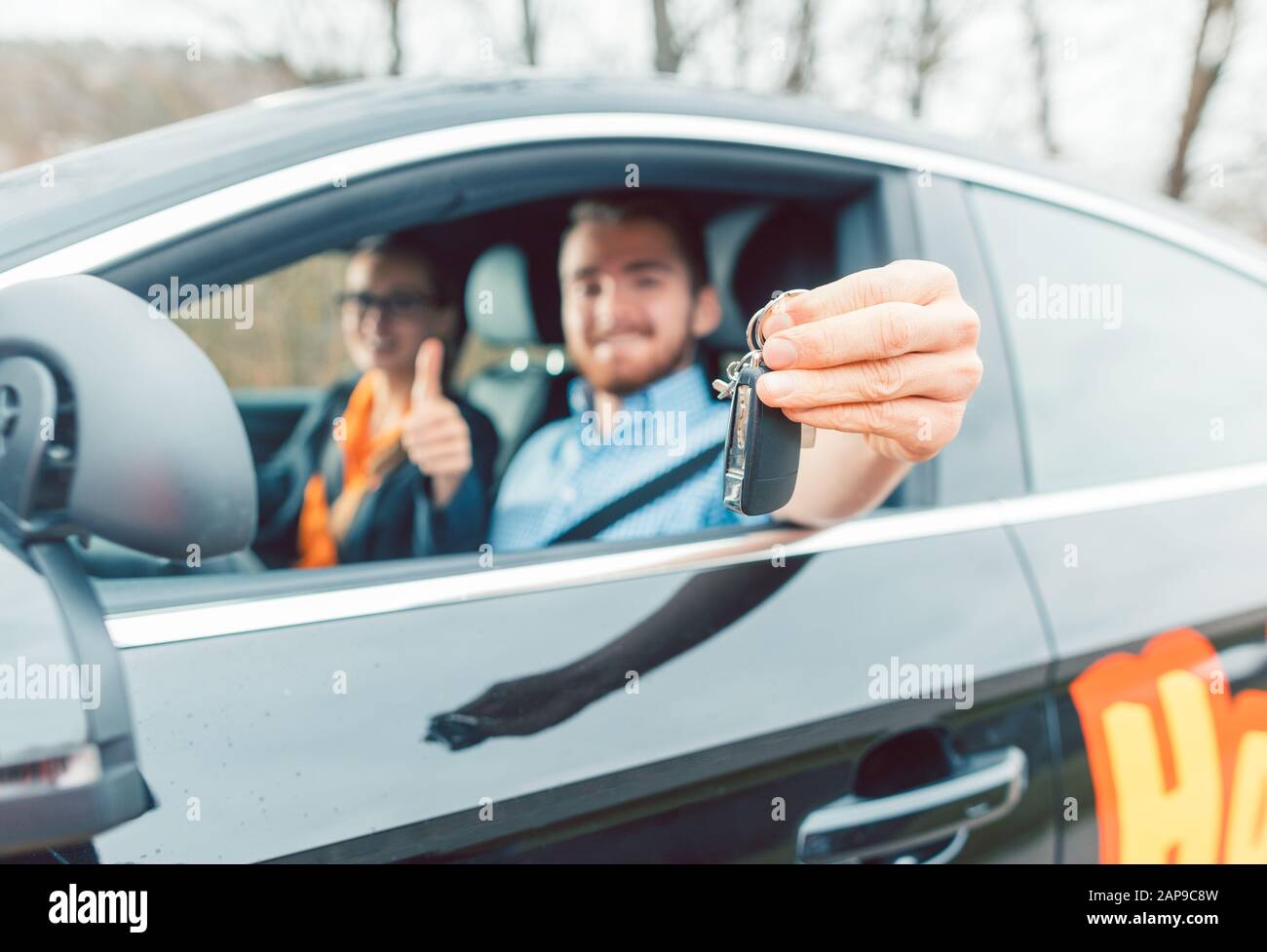 Student of driving school having passed his final test showing the car keys Stock Photo