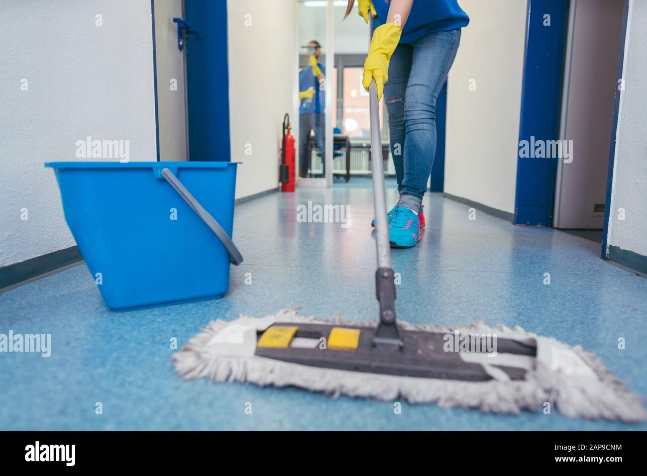 Close-up of cleaners moping the floor Stock Photo