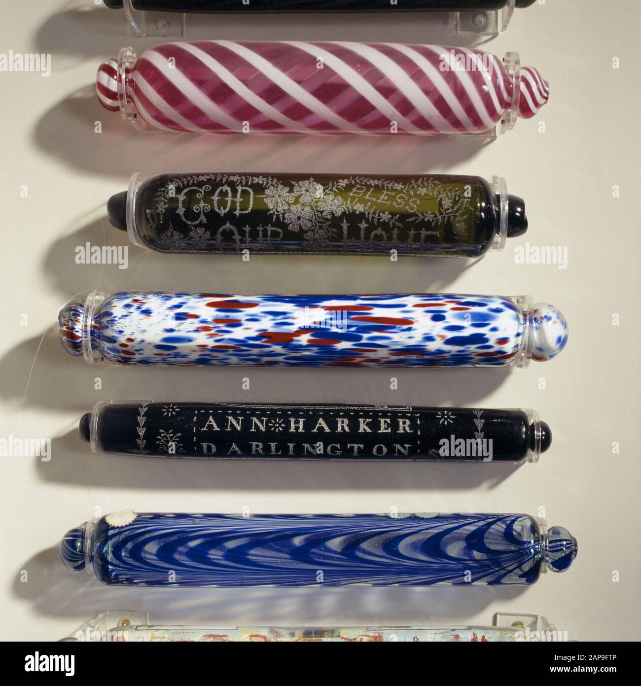 Some of the brightly coloured glass rolling pins mounted on a wall in the Justice Room. These were collected by Dame Dorothy, wife of Sir Ambrose Elto Stock Photo