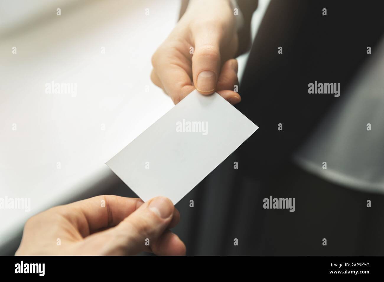 close up of people swapping blank business card. mockup Stock Photo