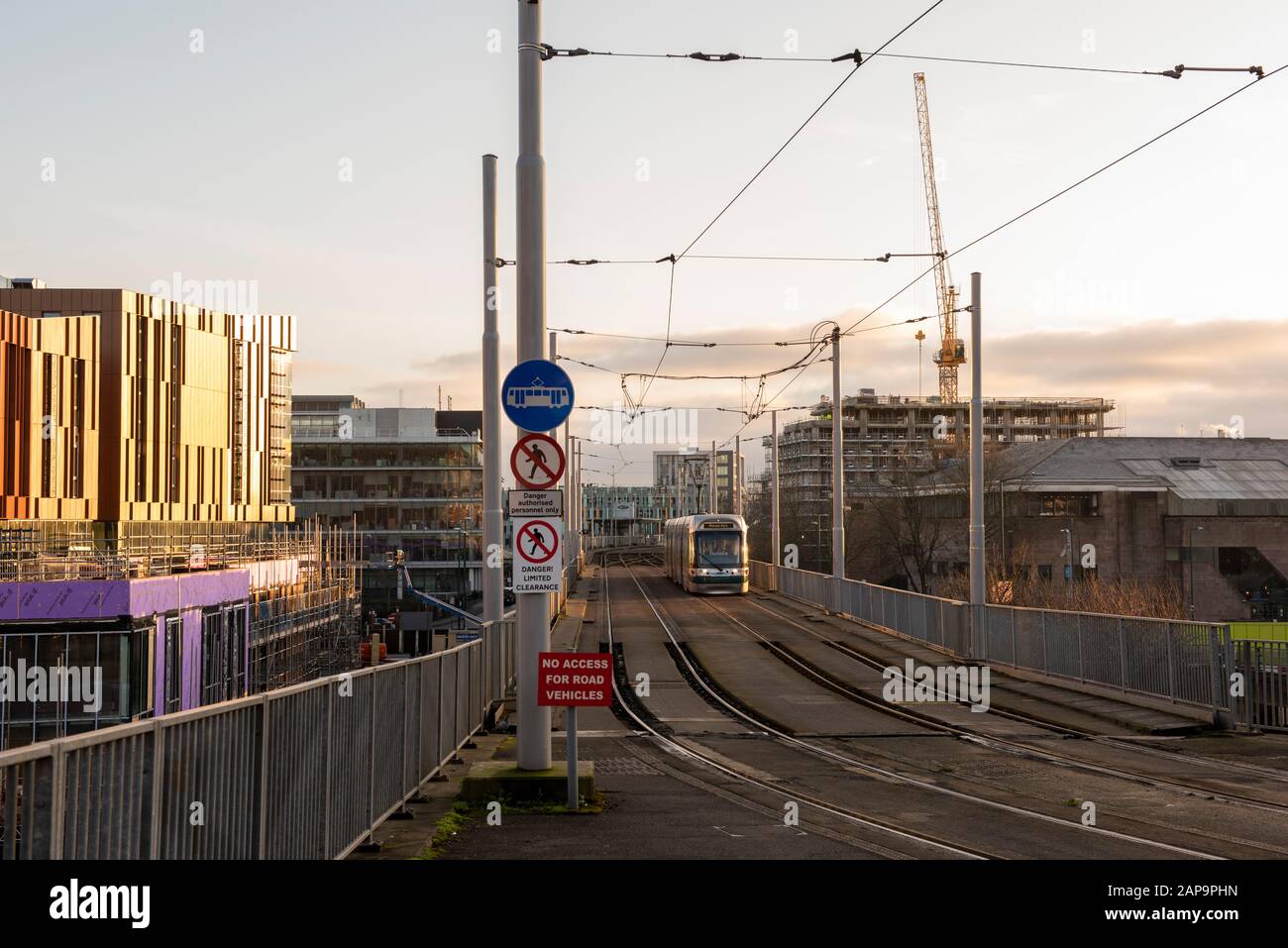 A tram passing the new Nottingham College Hub in Nottingham City South Side, Nottinghamshire England UK Stock Photo