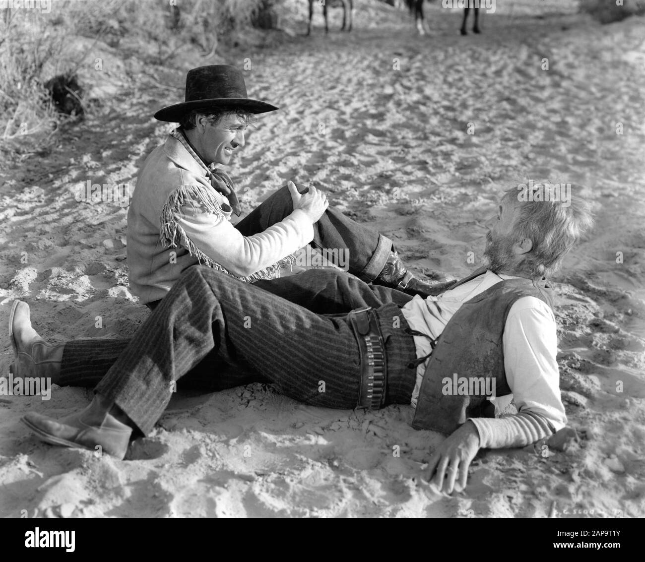 GARY COOPER as Cole Harden and WALTER BRENNAN as Judge Roy Bean in THE