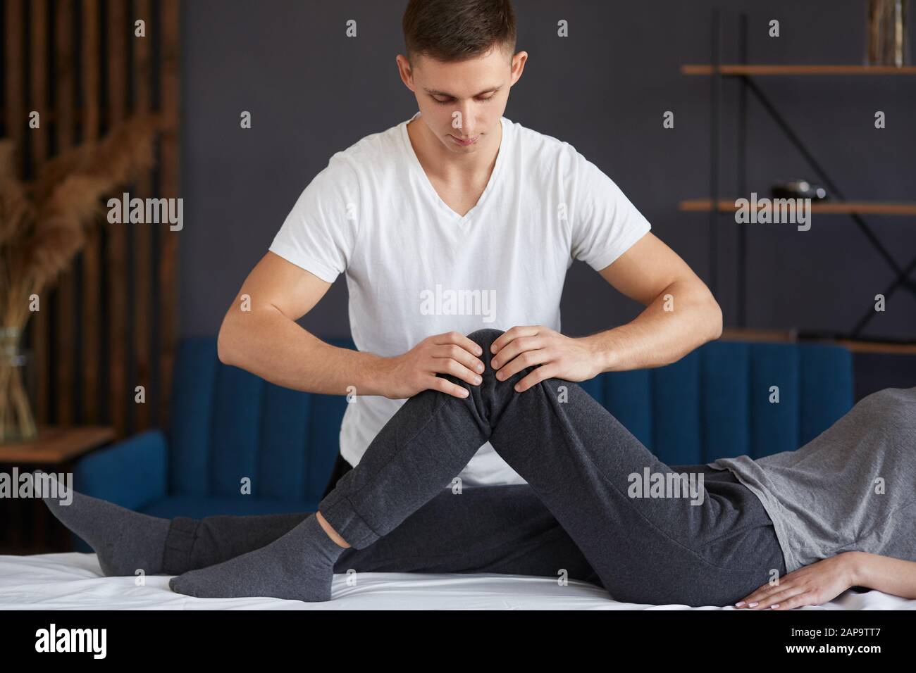 Female patient doing physical exercises with physiotherapist. Male
