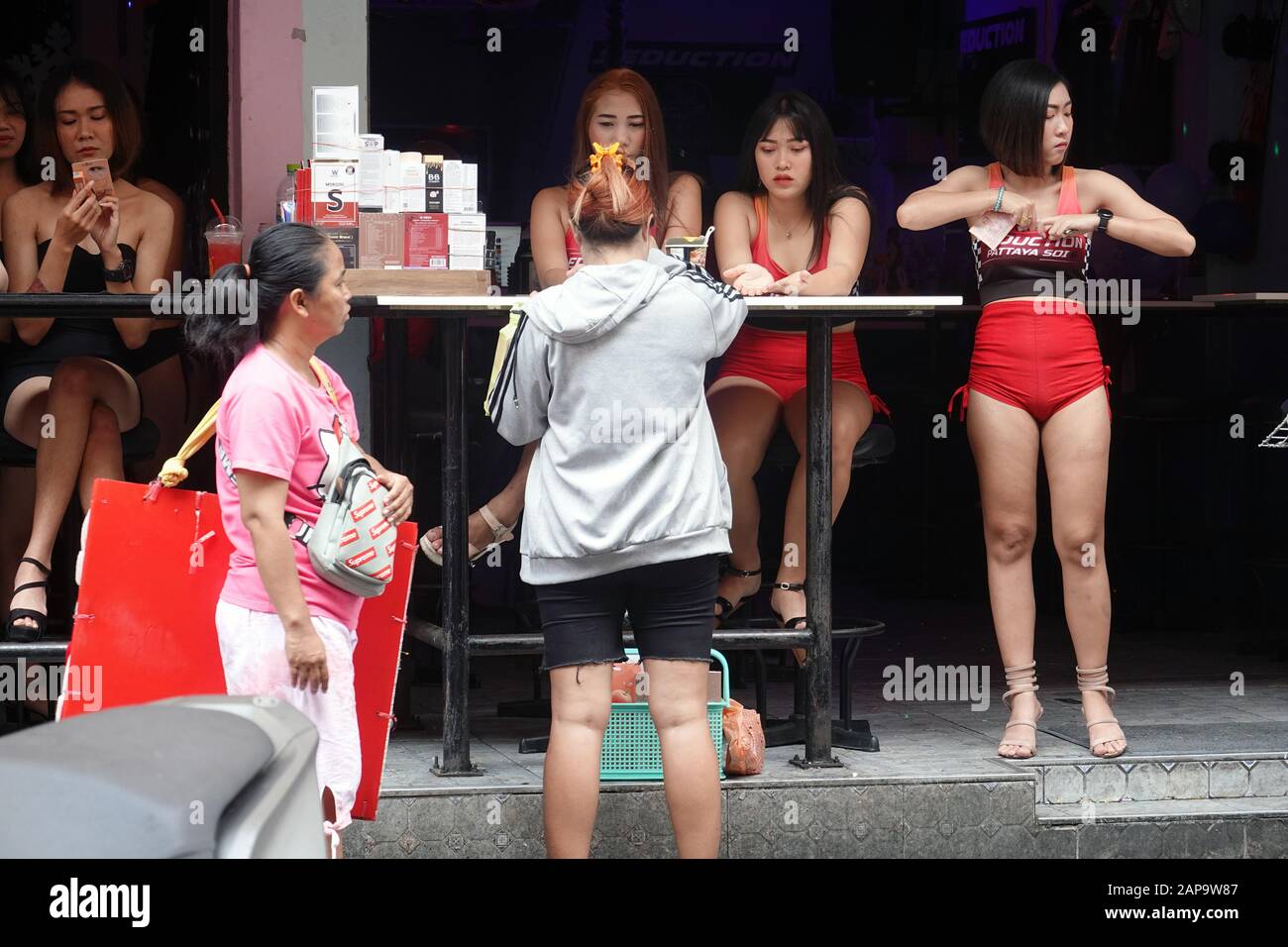 Pattaya, Thailand - December 22, 2019: Women on bar terrace on Soi 6. Stock Photo