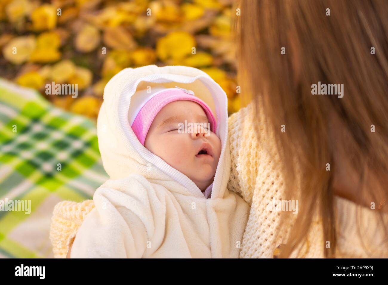 Twomonthold baby sleeps in mom's arms Stock Photo Alamy