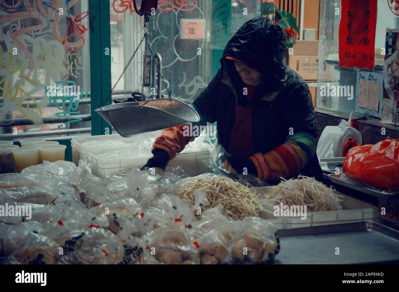 Seller serving food in a Street of Chinatown Stock Photo