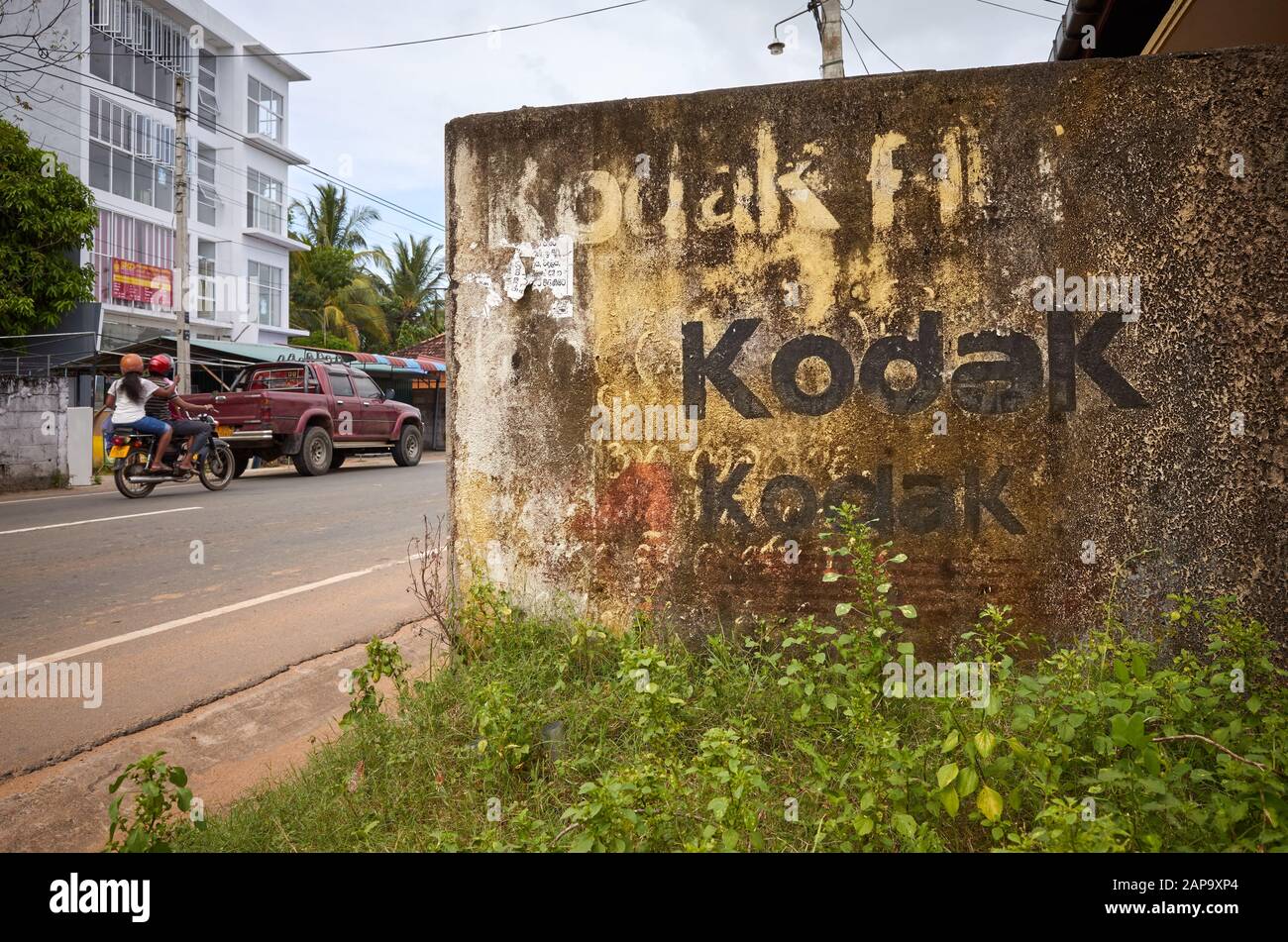 Tangalle, Sri Lanka: December 26, 2019: Peeling Kodak advertisement painting on an old building wall at the town main street. Stock Photo