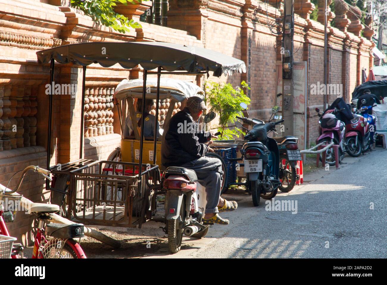 Chiang Mai  Worker waiting on bike in street  transport vehicles, Chiang Mai Thailand Stock Photo