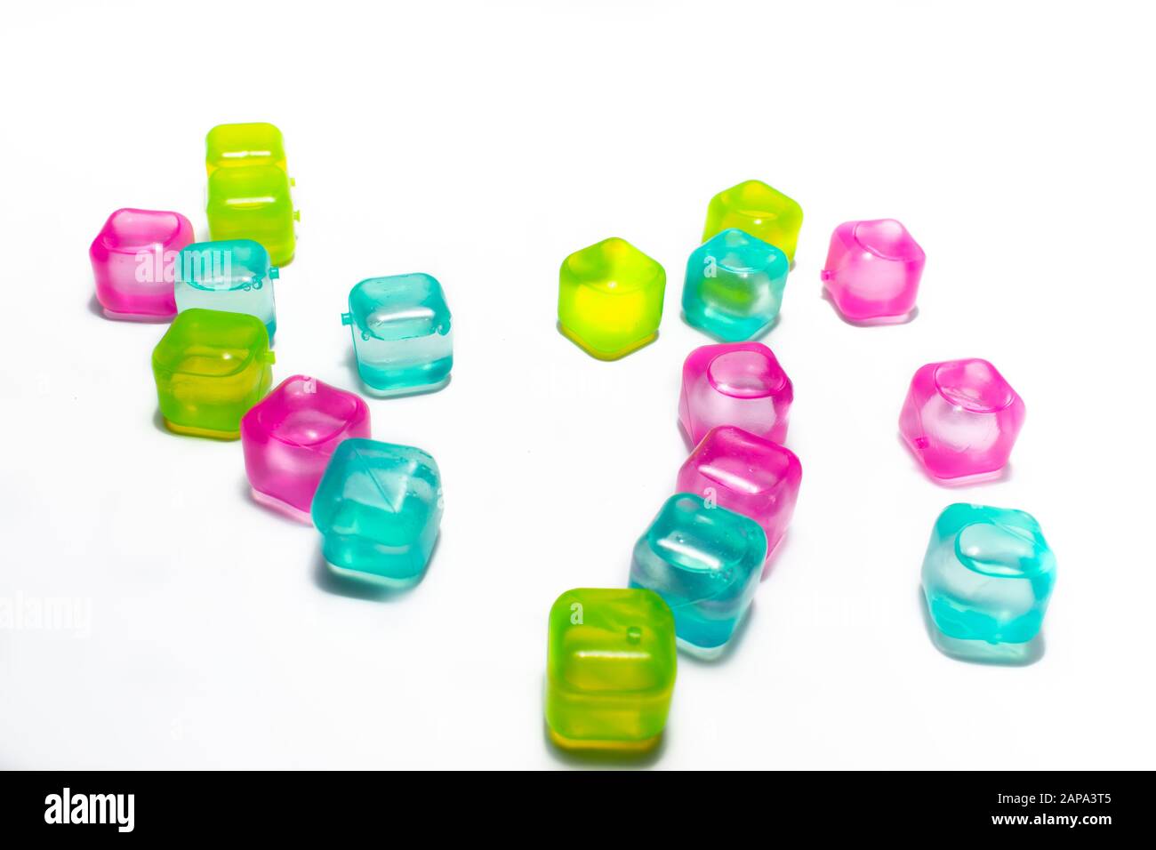 Multicolored cubes filled with liquid, arranged randomly, on a white