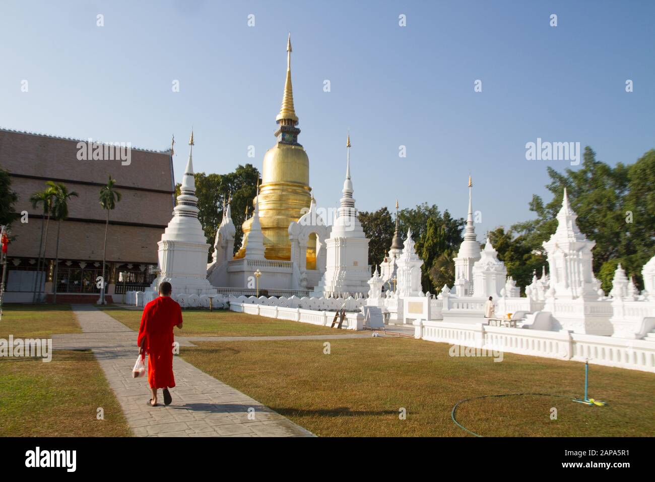 Thailand buddhist monk in orange dress walking in temple, Wat Suandok chiang Mai Thailand Thai Asia asian Stock Photo