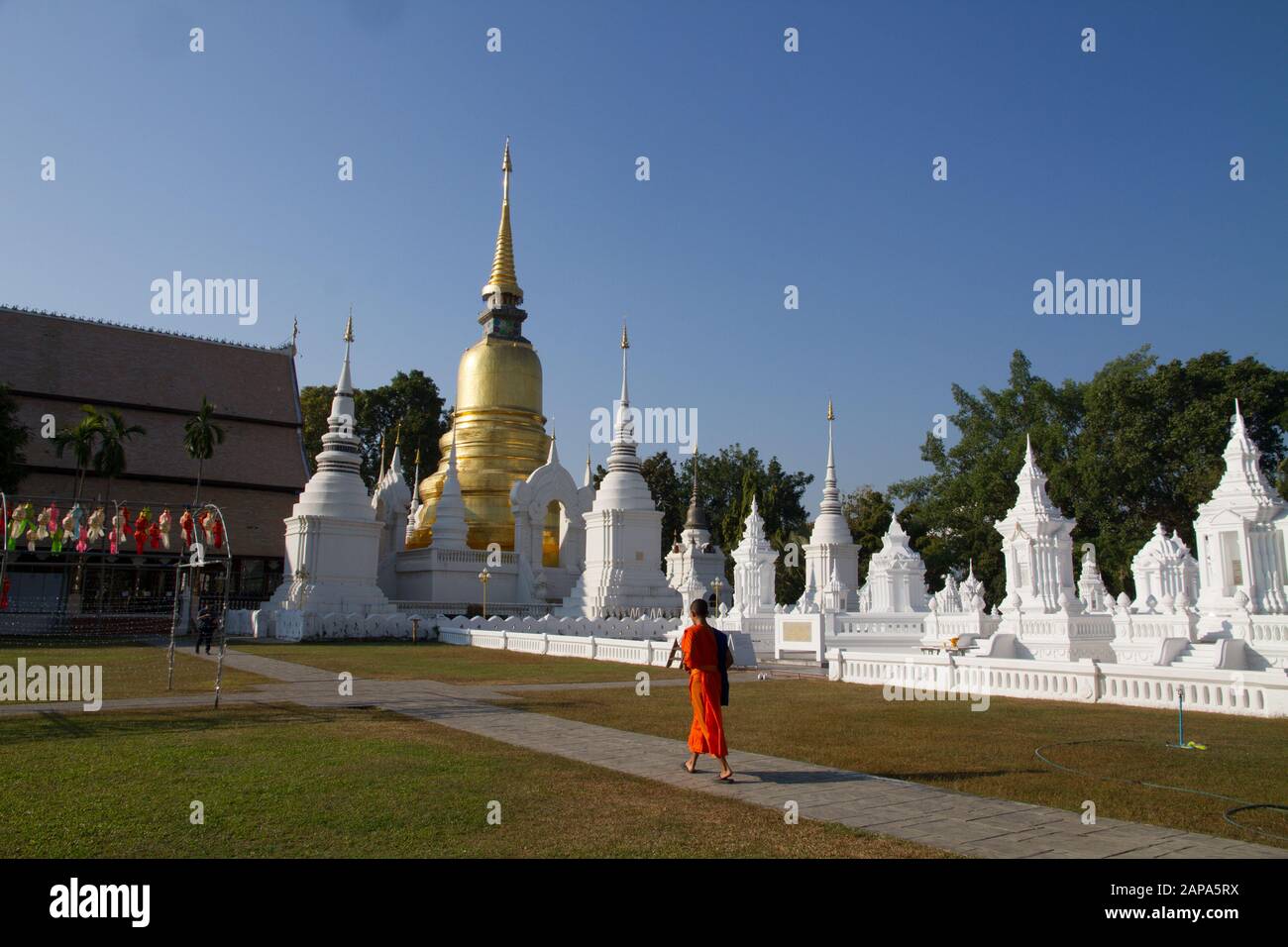 Thailand buddhist monk in orange dress walking in temple, Wat Suandok chiang Mai Thailand Thai Asia asian Stock Photo