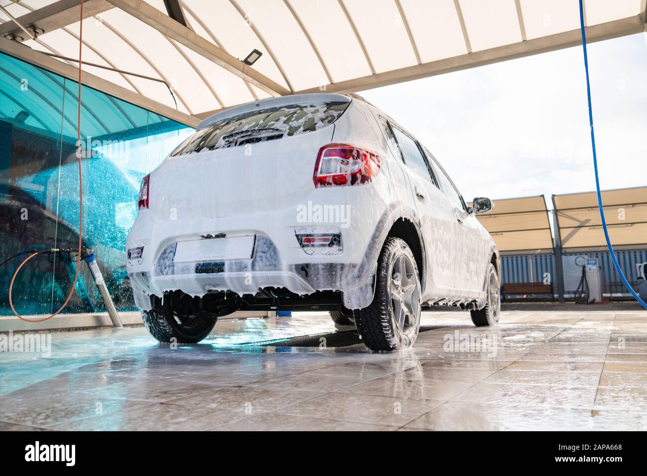 Self service high pressure car wash. Vehicle covered with foam Stock Photo
