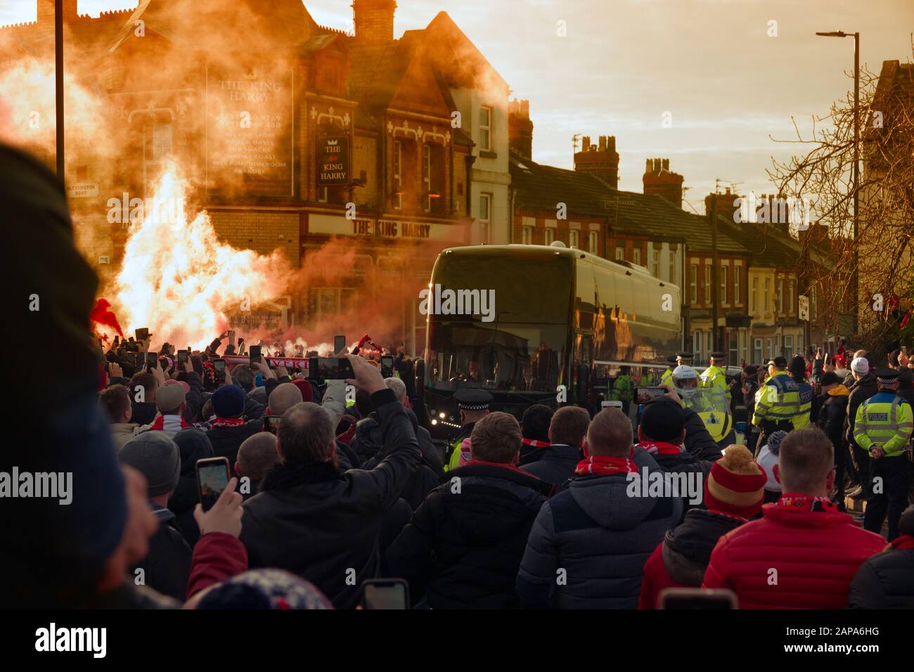 LFC fans give the Manchester United coach a hostile reception with pyro and flares prior to their Premier League game at Anfield. Stock Photo