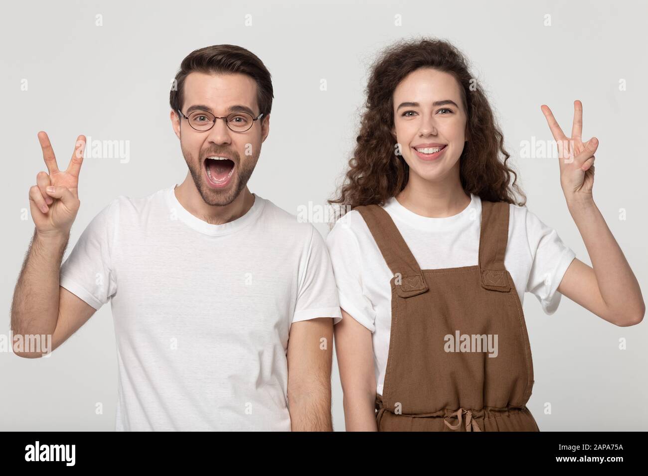 Studio portrait excited young man and smiling curly woman Stock Photo ...