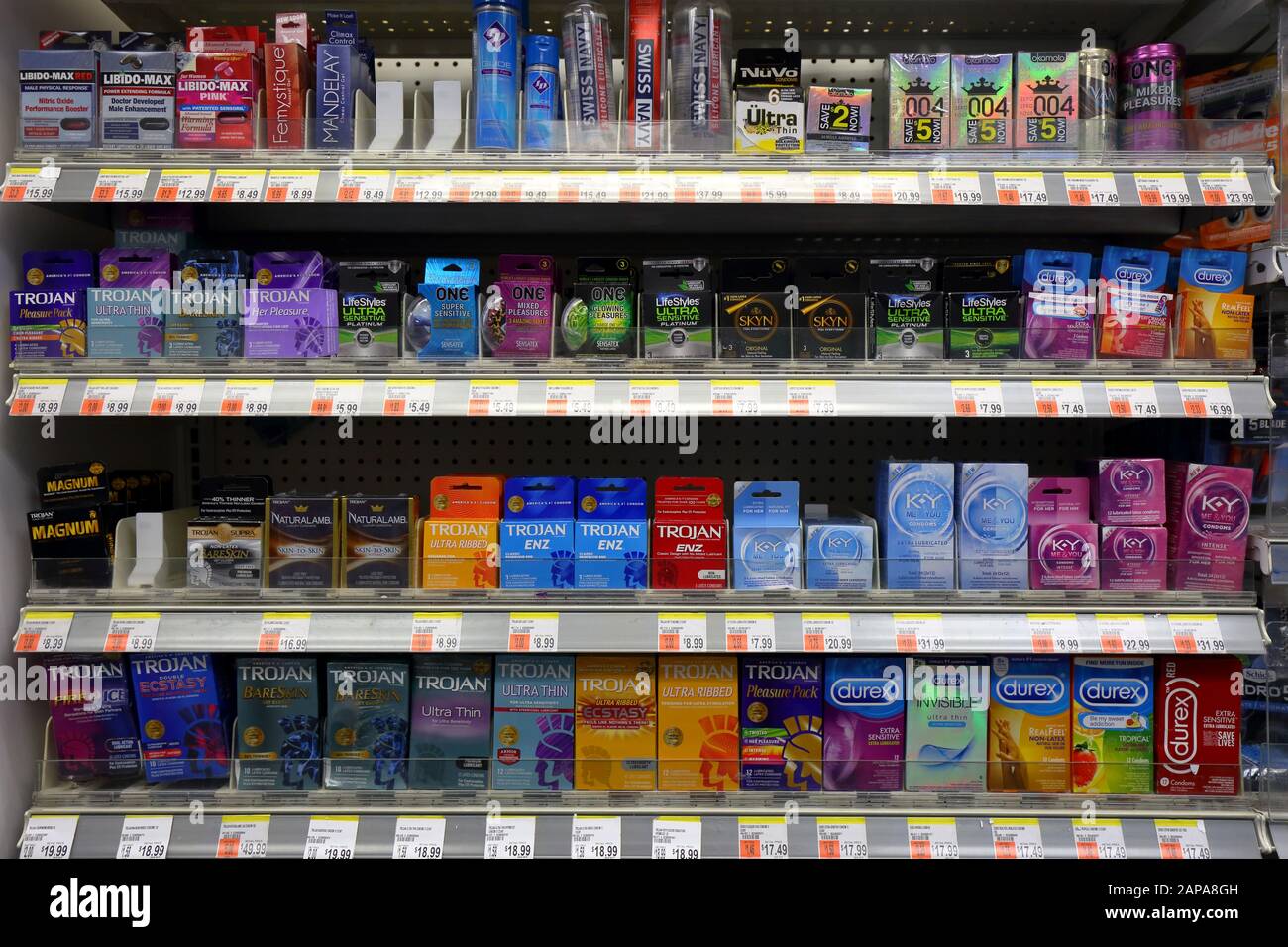 A wide variety and different brands of condoms on a store shelf at a drug store pharmacy Stock Photo