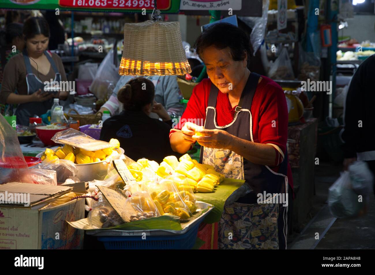 Chiang Mai Market stall fruits woman seller preparing Thailand Stock Photo