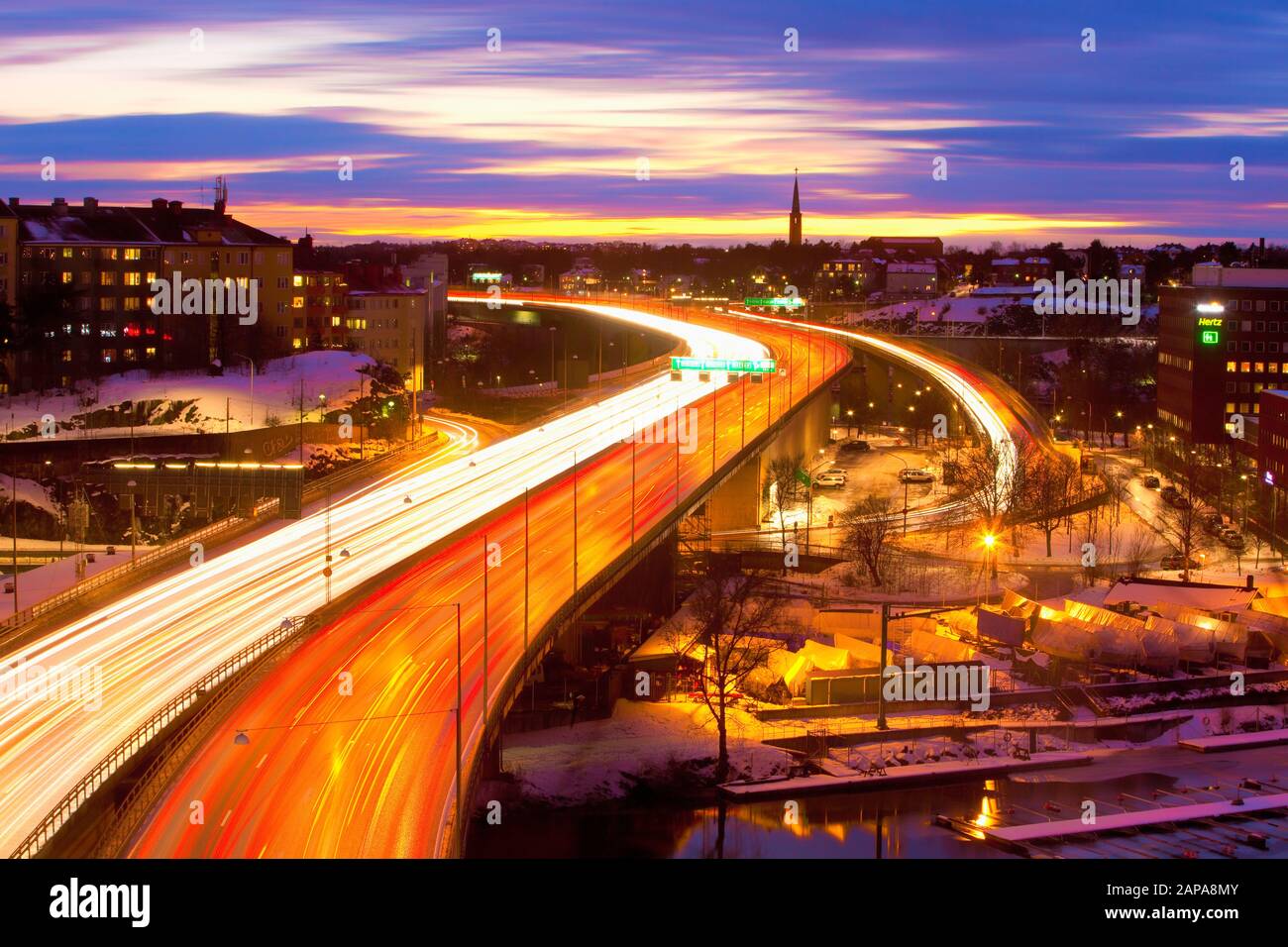 Sweden, Stockholm - Traffic on Essinge Highway at Dusk Stock Photo