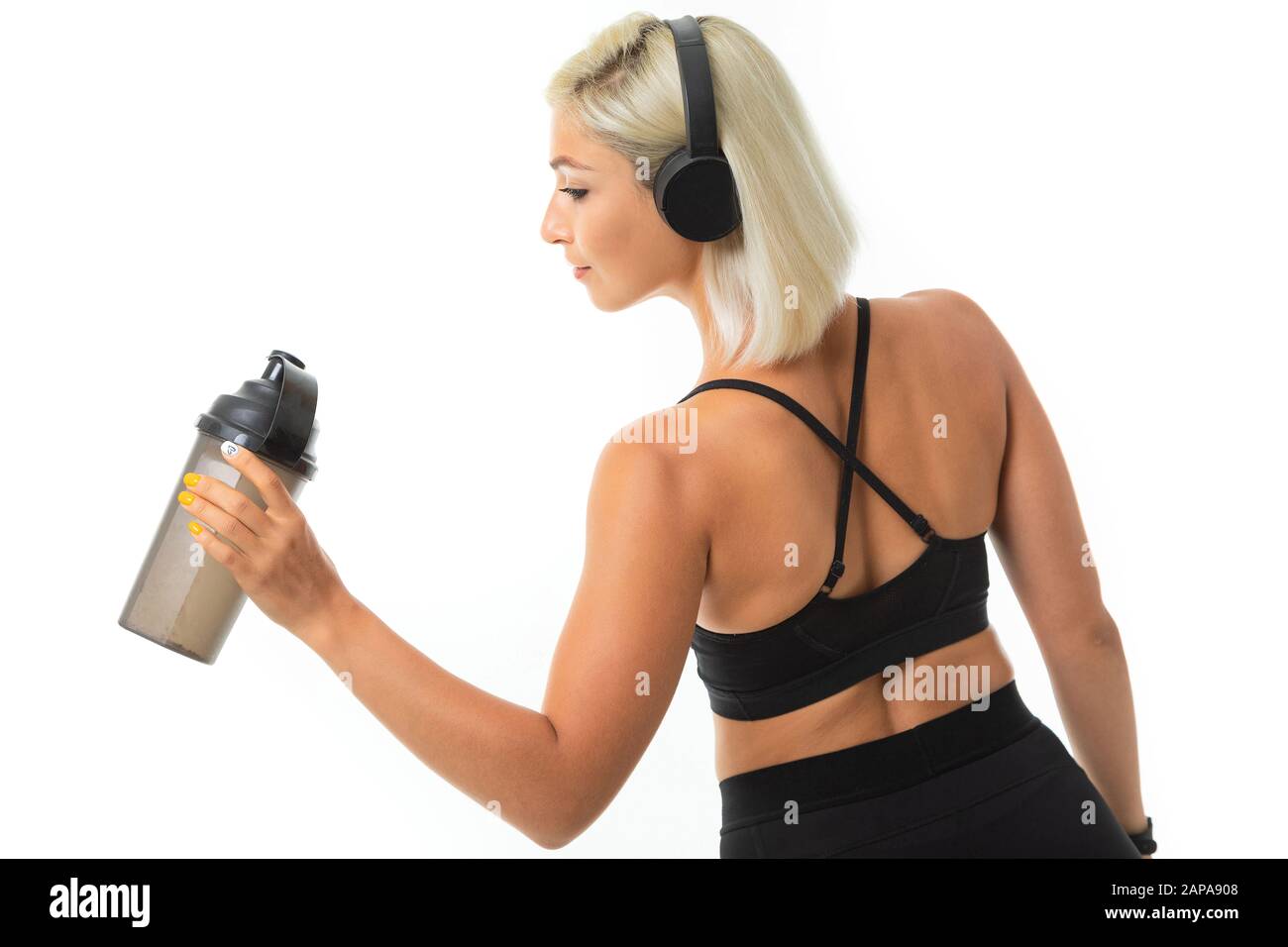 Caucasian sport woman with blonde hair listen to music with big ...