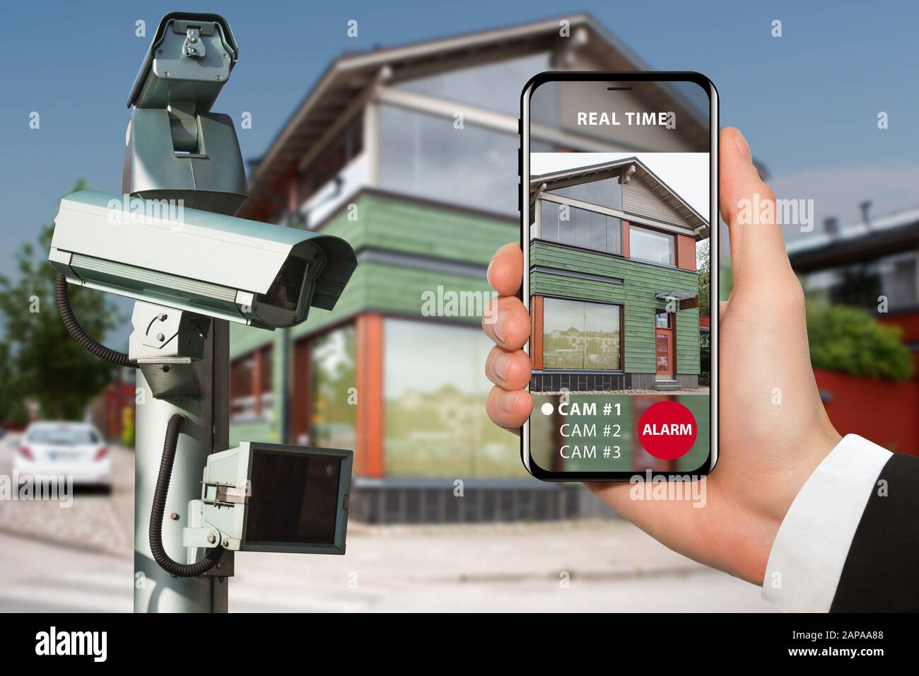 Hand with phone. On the screen interface of remote control surveillance camera Stock Photo
