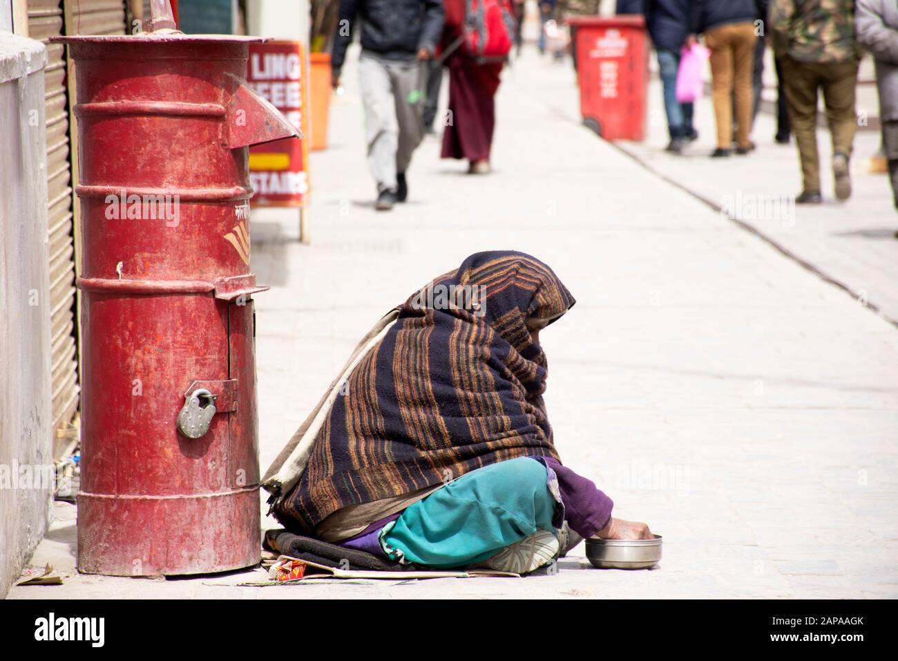 JAMMU KASHMIR, INDIA - MARCH 19 : Old indian women beggar or untouchables caste sitting and begging money from travelers people in market at Leh Ladak Stock Photo