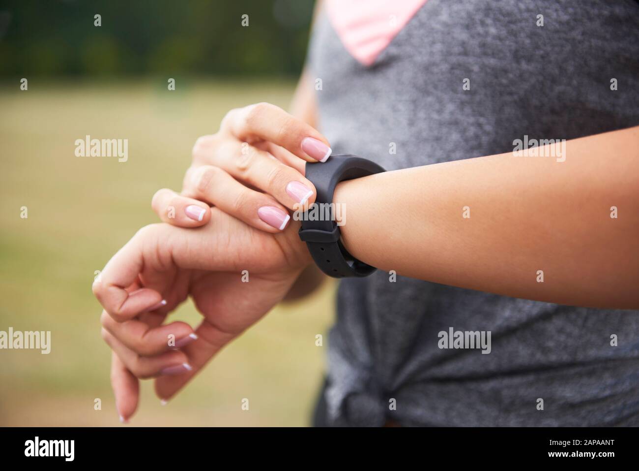 Young woman checking how many calories she burned Stock Photo