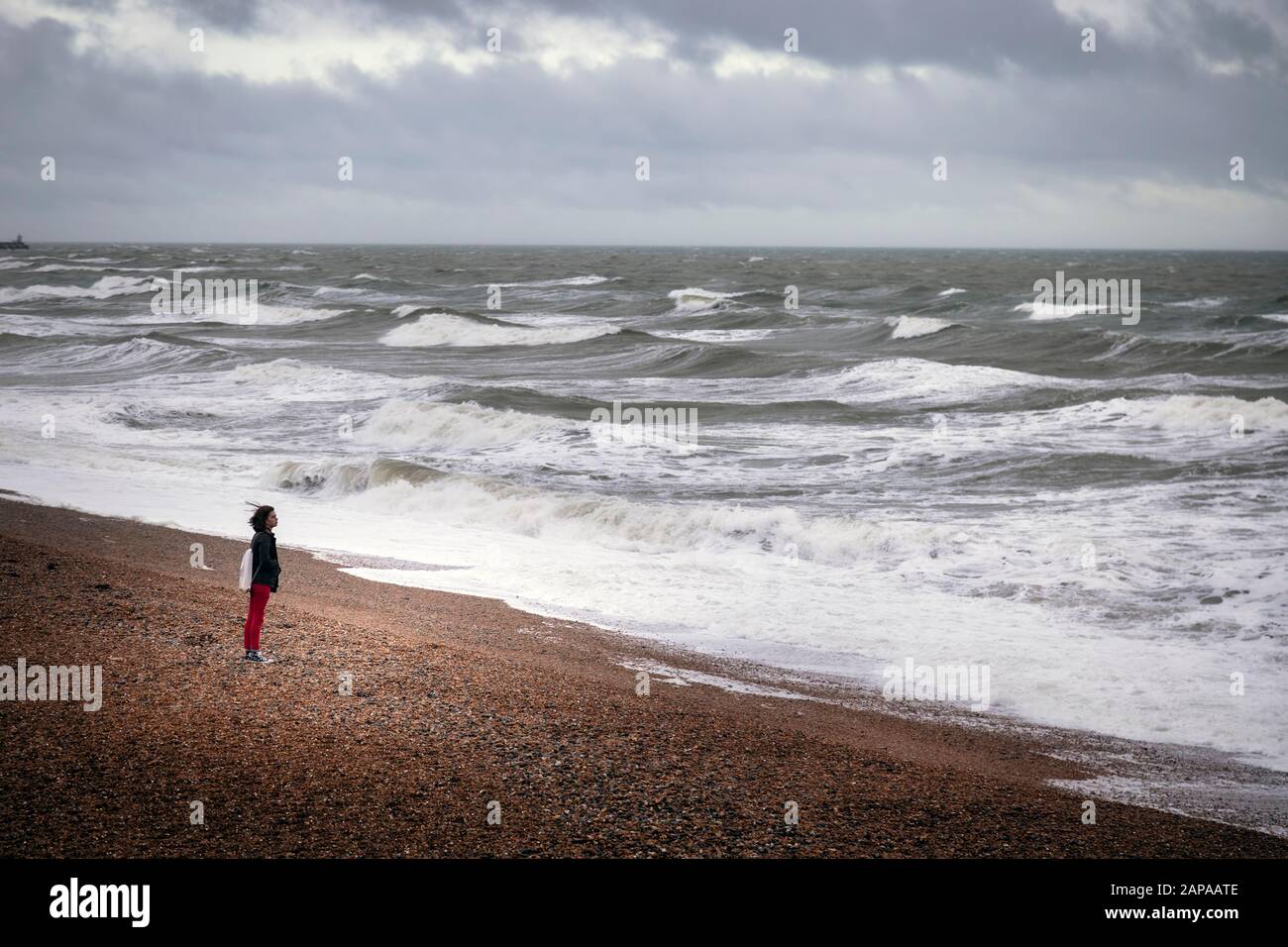woman standing on  Brighton beach Stock Photo