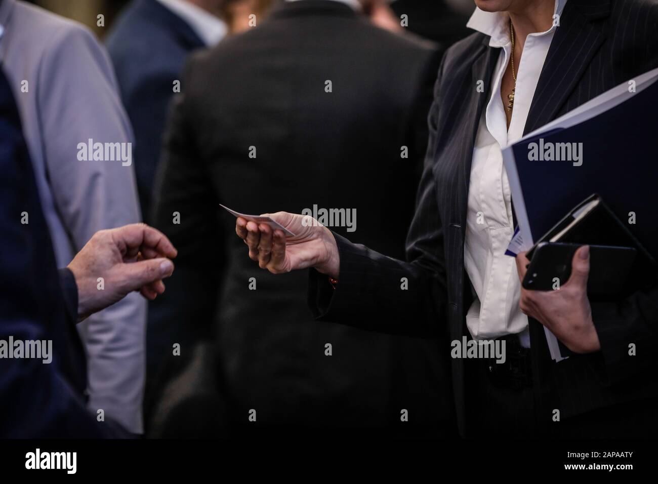 Details with the hand of a business woman receiving a business card Stock Photo