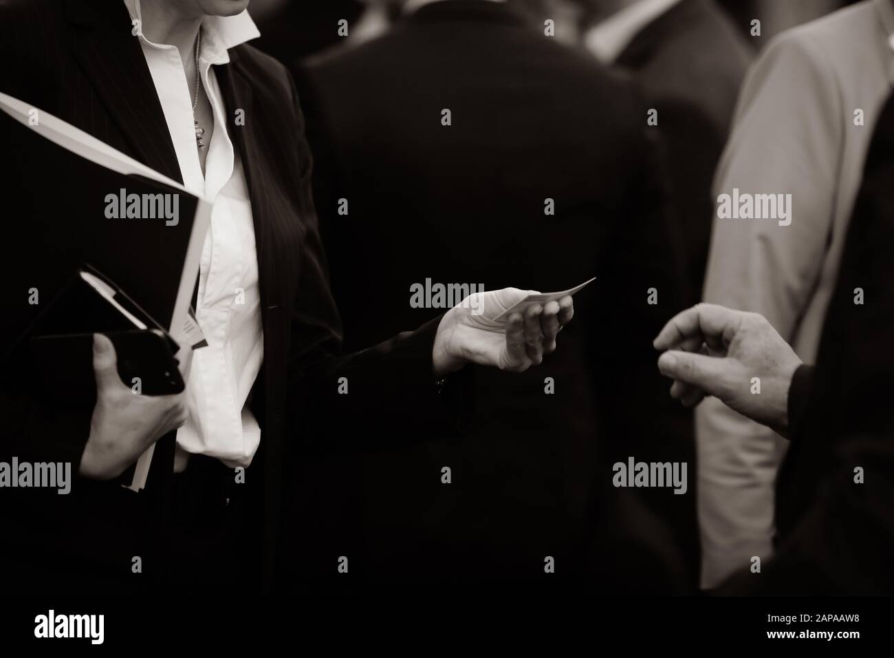 Details with the hand of a business woman receiving a business card Stock Photo