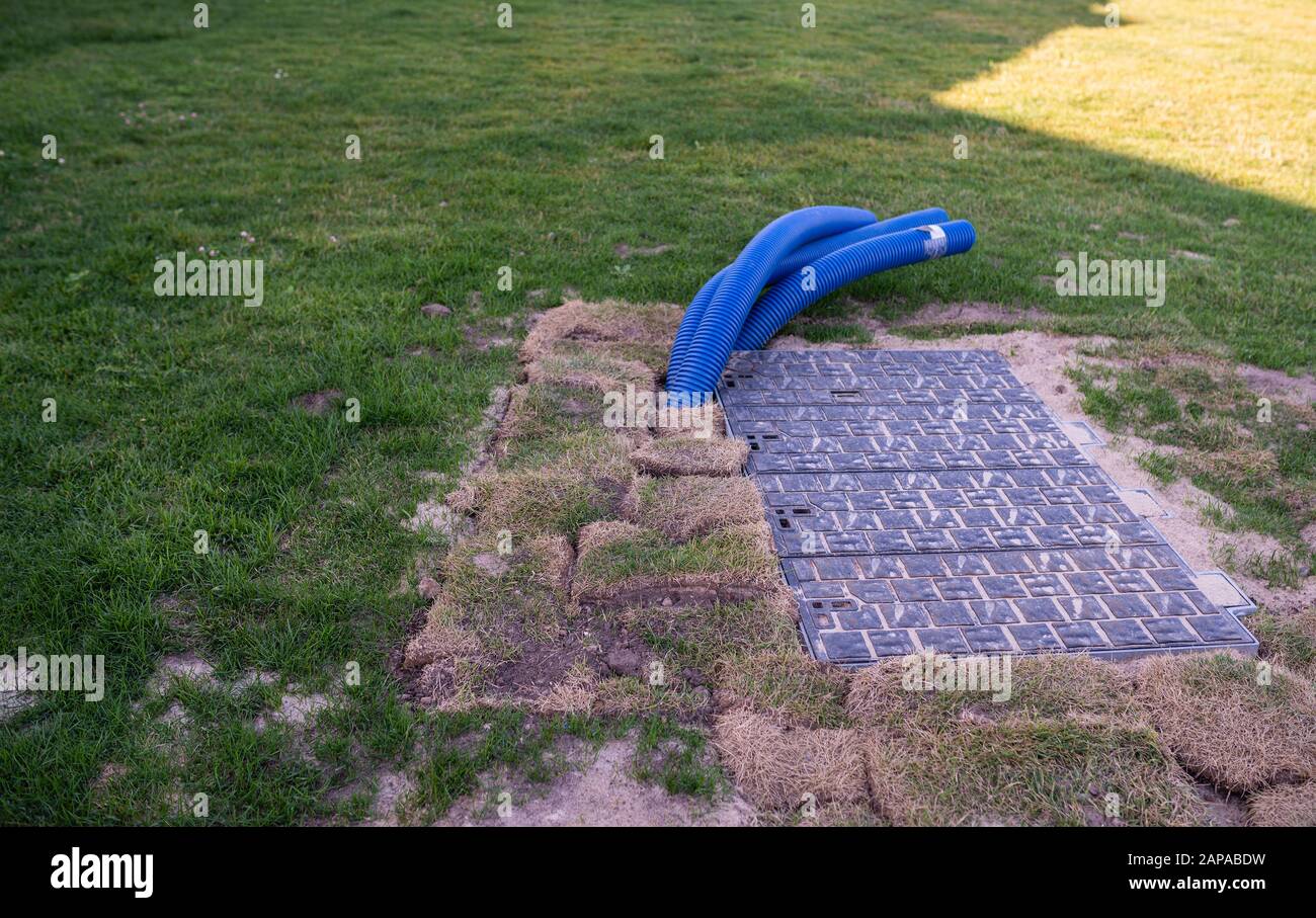 Pipes stick out from under the ground Stock Photo Alamy